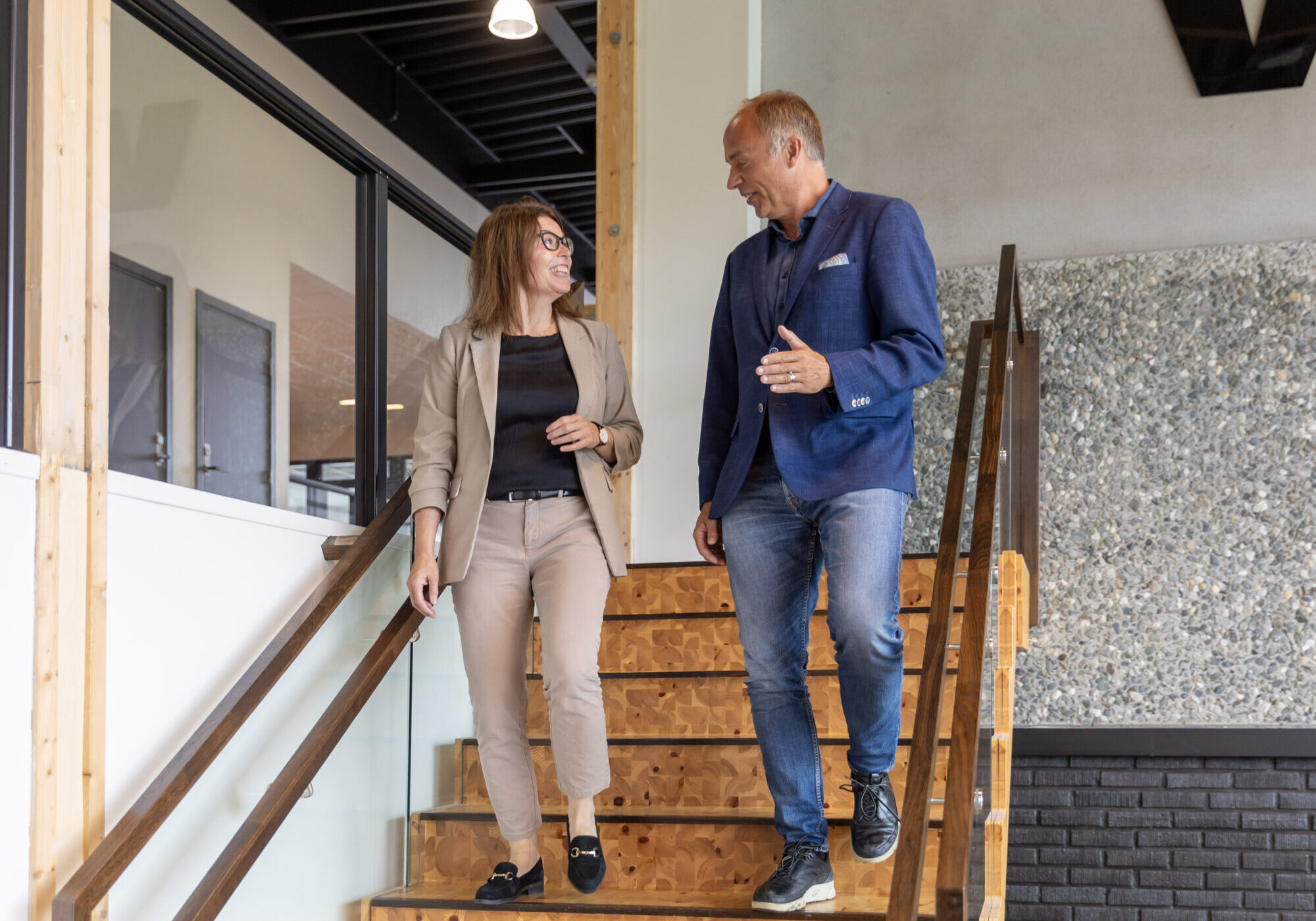 Employees walking down stairs while talking